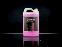 Cleaning automotive windshield with Dialed In Details Glass Cleaner