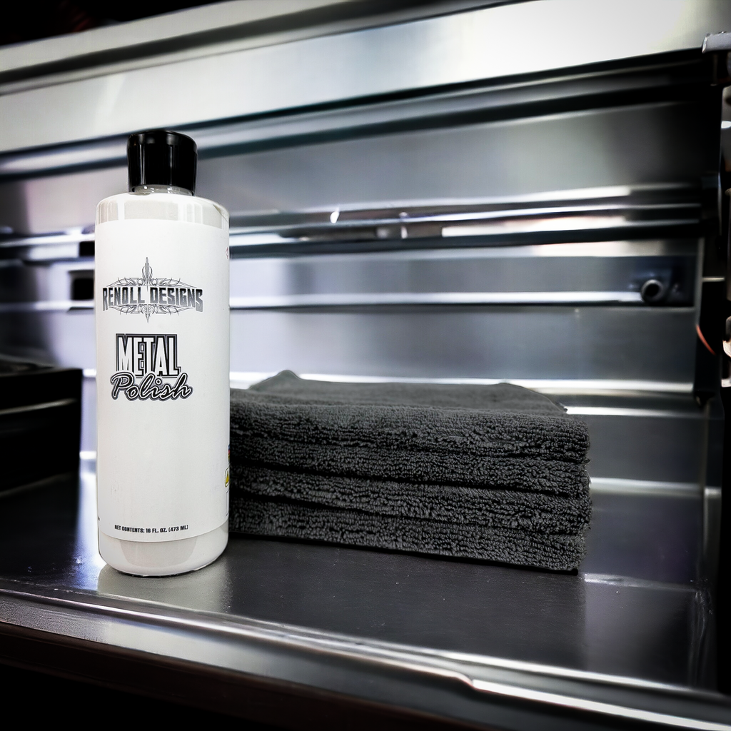 Wiping metal polish residue with microfiber towel after polishing