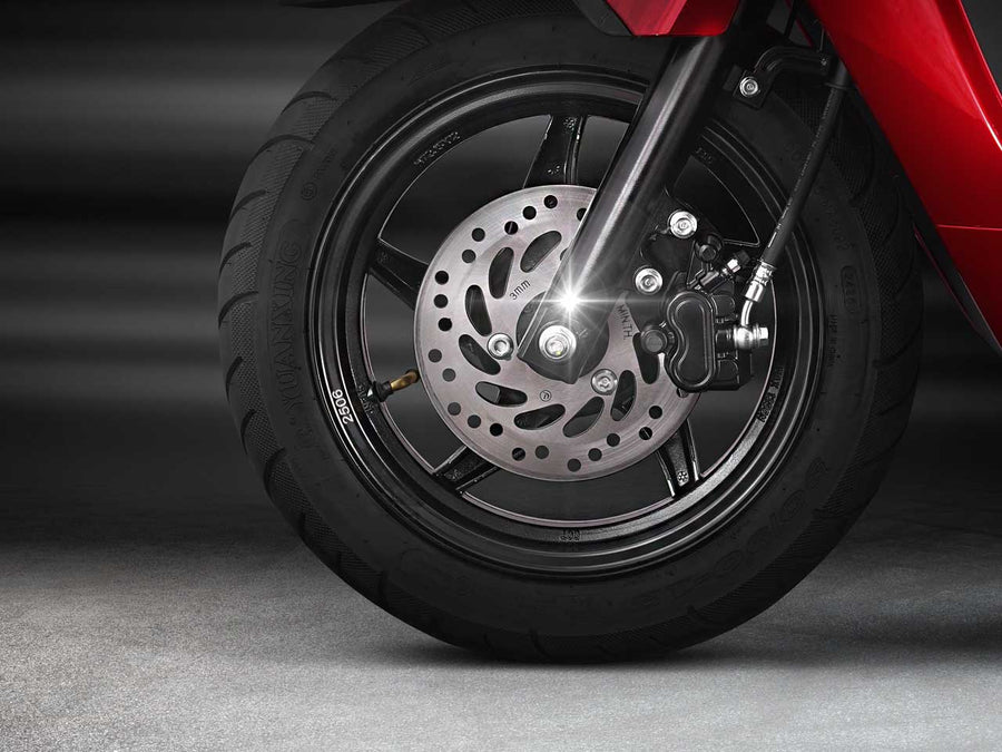 Scootstar Modstar 150 front wheel disc brake and tire close up
