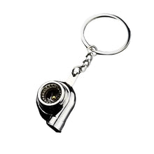 metal turbo keychain with spinning compressor wheel detail close up